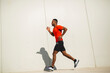 © mimagephotos - Full length side portrait african american man running
