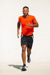 Man jogging outdoors in city on a bright sunny day