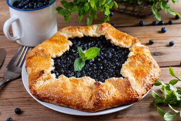 Wall Mural - Pie with fresh and cooked blueberries on wooden table