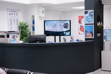 Wall Mural - Empty hospital reception counter with computer, making healthcare appointments for patients with disease. Registration work with medical checkup reports and papers forms in facility lobby.