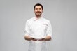 © Syda Productions - cooking, culinary and people concept - happy smiling male chef holding empty plate over grey background