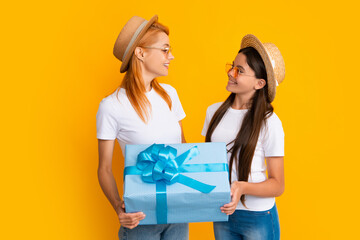 Poster - Mother gives a gift to her teen daughter, isolated background. Happy family concept. Girl with mother together. Valentine.