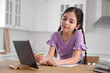 © New Africa - Little girl doing homework with modern tablet at home