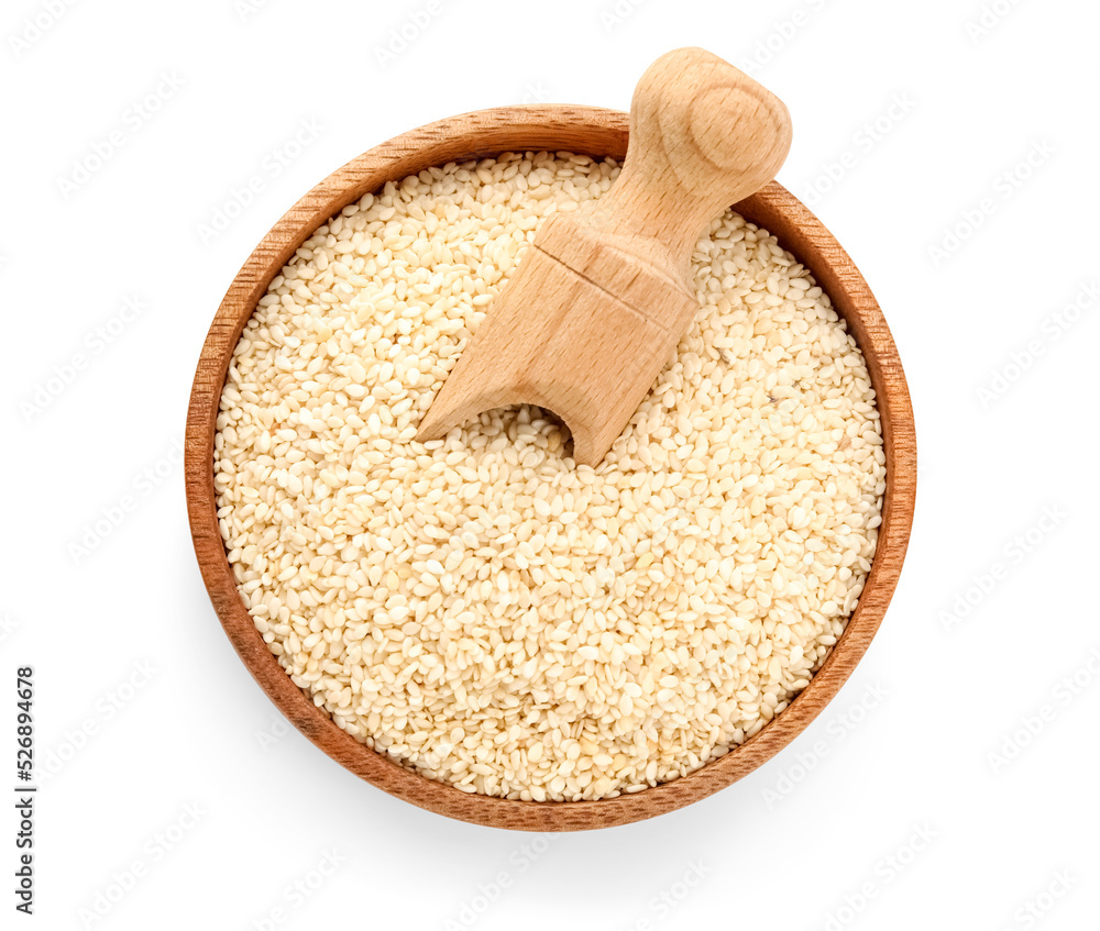 Bowl and scoop of sesame seeds on white background