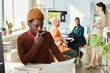 © Seventyfour - Portrait of creative black man planning project and reading document at office workplace