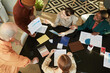 © Seventyfour - Top view at creative business team meeting in office, diverse group of people sitting at table