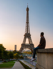 Sticker - Young men watching sunrise by the Eiffel tower, Eiffel tower at Sunrise in Paris France, Paris Eifel tower on a summer day in the city of Paris France