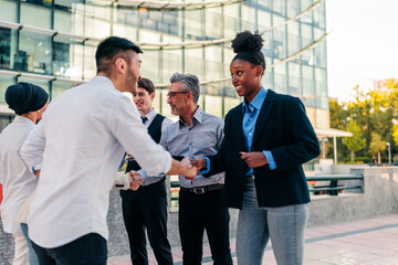 Wall Mural - Group of business people greeting in street