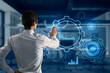 © Who is Danny - Back view of young businessman pointing at glowing cogwheel and chart hologram on blurry office interior background. Business analytics and finance concept. Double exposure.