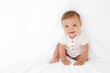 © Lisa Tichané - Cute smiling baby girl hiding under white sheet