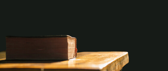 Sticker - Bible of christian put on wooden table with light in morning. Close up concept.
