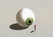 © fStop - Woman standing at large green eyeball