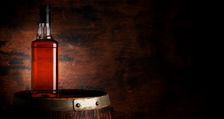 Wall Mural - Bottle of whiskey on the old barrel