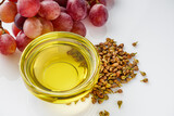 Fototapeta Kuchnia - grape seed essential oil on a white background