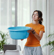 © StockPhotoPro - Woman collecting water leaking from the ceiling