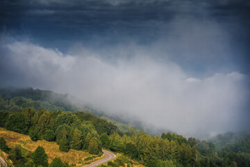 Wall Mural - Beautiful summer mountain landscape, clouds over a small village in a mountain gorge in Serbia