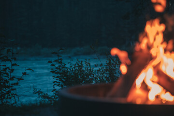 evening campfire in the forest by the river