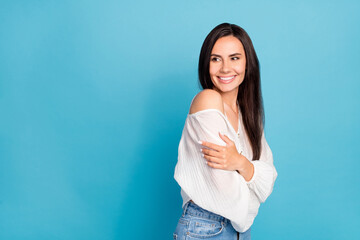 Sticker - Photo of sweet dreamy young lady wear white top hugging herself looking empty space isolated blue color background