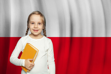 Wall Mural - Cute curious little school girl against Polish flag background. Education in Poland concept.