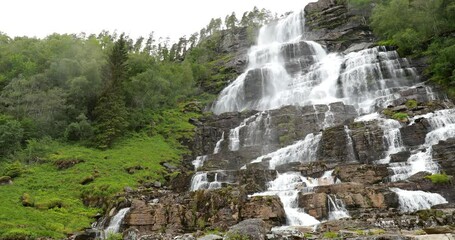 Wall Mural - Voss, Hordaland, Norway. Waterfall Tvindefossen In Spring. Waterfall Tvindefossen Is Largest And Highest Waterfall Of Norway. Famous Natural Norwegian Landmark And Popular Destination. Panorama. 4K.