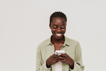 Young beautiful smiling happy african woman using phone