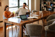 © Drobot Dean - White young colleagues discussing project while working in office
