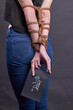 Back view bound girl holds molecule of cocaine. Vertical shot of young roped girl. Dron dependence and addiction concept.