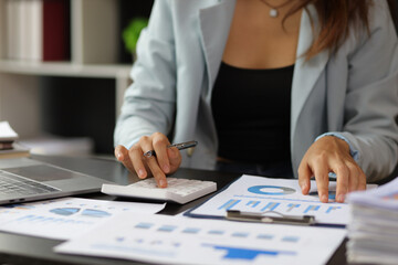 Wall Mural - Business woman accountant working in office checking financial accounts and allocating company budgets.