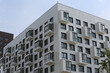 © Sergey - New building facade in housing complex 'Green Park. PIK', Moscow city, Russia. Modern style in architecture. Contemporary house in dormitory area. Urban landmark, home. White facade of building
