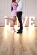 © racool_studio - Beautiful young couple with man and woman posing in studio