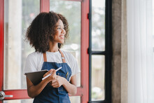 African American Female Small Business Owners.holding A Laptop Standing At The Entrance To The Store Coffee Leaning On Door With Open Sign SME Entrepreneurs Business