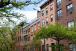 Row of Old Colorful Brick Residential Buildings along a Street in Chelsea of New York City