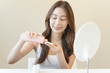 © Pormezz - Asian young woman preparing to clean makeup by toner and wipe cotton