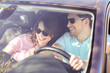 © racool_studio - The happy couple travel in their car