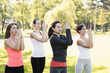 © racool_studio - A group of healthy, beautiful, athletic women in sporty clothes doing yoga in the park.