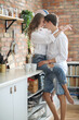 © racool_studio - Photoshoot of a young couple of woman and man in white T-shirts at home