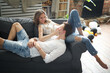 © racool_studio - Photoshoot of a young couple of woman and man spending time together on sofa