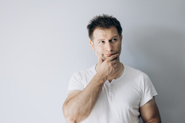 Sticker - Guy programmer in a white t-shirt holds thinking