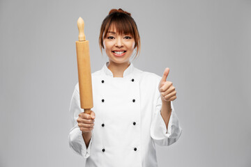 Sticker - cooking, culinary and people concept - happy smiling female chef or baker with rolling pin showing thumbs up over grey background