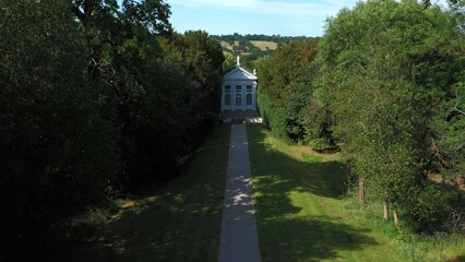 Aerial top down view from the drone onto the narrow passageway leading to a small chapel. Chapel located in a big green open area of fields near Rosary Manor, Mill Hill, North West London, London, UK.