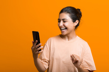 Portrait of young adult indian woman with mobile phone