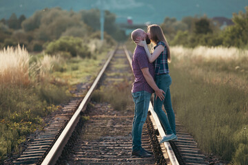 Canvas Print - Young happy couple on the tram railways