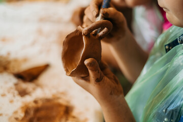 Wall Mural - children's hands sculpts clay crafts pottery school