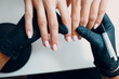 Manicure process female hands finger nails polish.