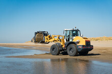 Excavator Cleaning A Beach From Seaweed And Algae, By Using A Customized Truck.
