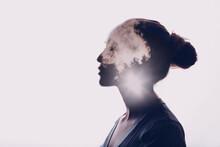 Psychology And Woman Mental Health Concept. Multiple Exposure Clouds And Sun On Female Head Silhouette.