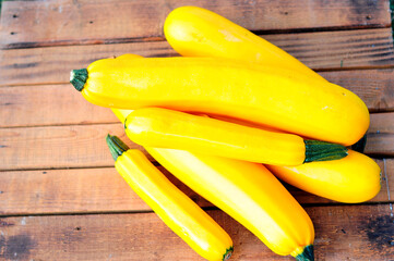 Wall Mural - Four juicy ripe, yellow zucchini on a wood table, close-up, harvest vegetable,
