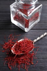 Dried saffron on black wooden table, closeup