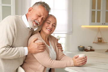 Wall Mural - Happy senior couple spending time together in kitchen