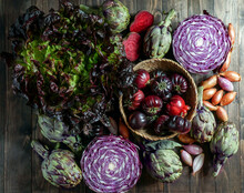 Violet Vegetables On The Wooden Background, Purple Artichoke, Tomatoes, Oniones, Salad